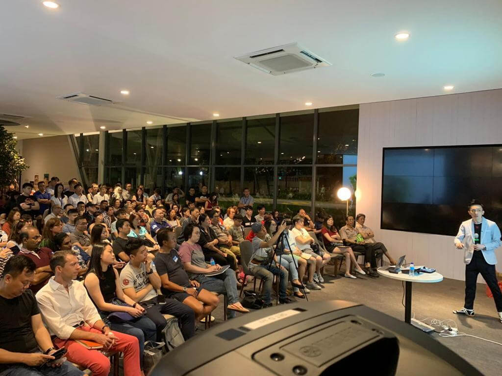 Seminar speaker presenting to a packed audience